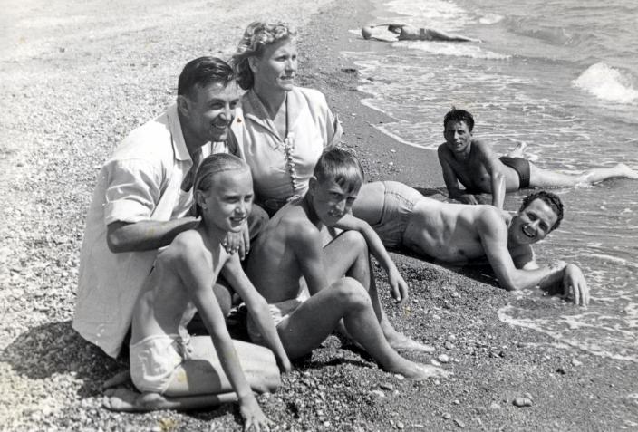Nada and her family sitting on a beach 
